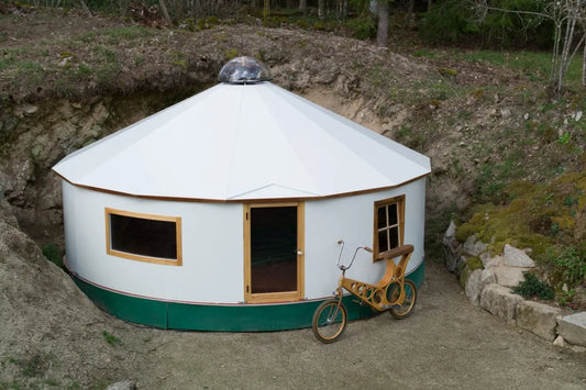 A yurt nestled into a hillside in the mountains of Colorado